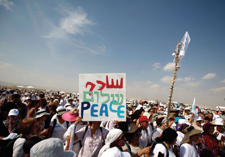 Activists, including Israelis and Palestinians, take part in a demonstration in support of peace near Jericho (credit: REUTERS)