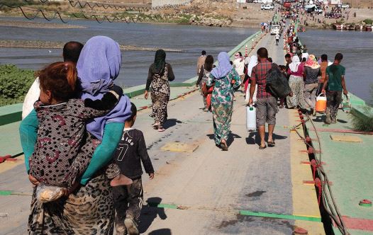 YAZIDI WOMEN and men flee Islamic State on August 10, 2014 in northern Iraq. Many were captured by ISIS, raped tortured and executed, a crime that continues to this day. (credit: REUTERS)