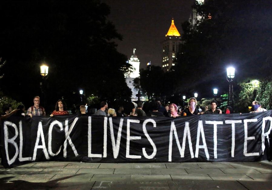 People hold up a banner during a Black Lives Matter protest outside City Hall in Manhattan, New York (credit: REUTERS)