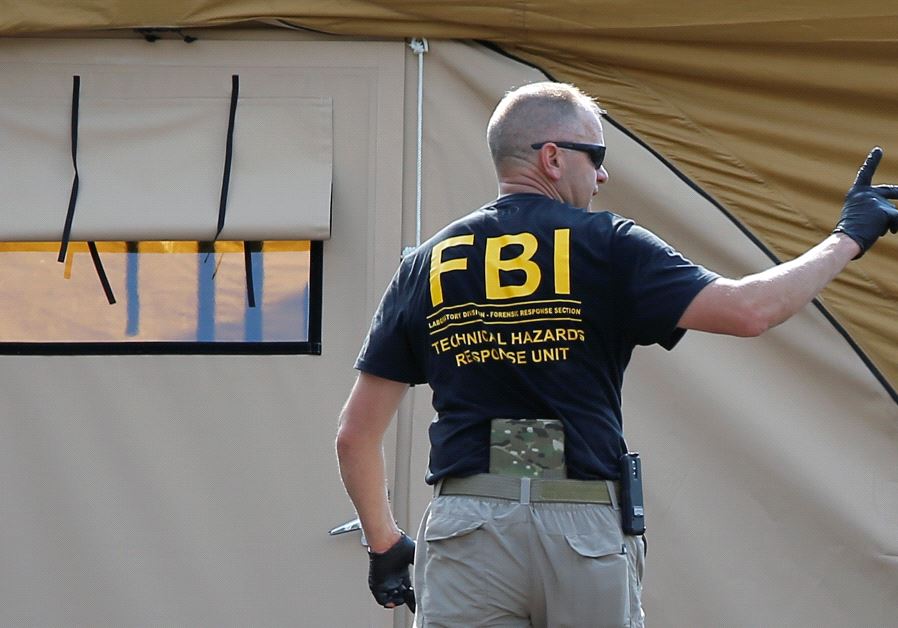 An FBI investigator  (credit: REUTERS)