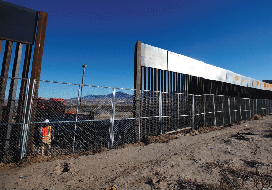 A WORKER STANDS next to a newly built section of the US border fence at Sunland Park, New Mexico, opposite the Mexican border city of Ciudad Juarez, on Wednesday. Picture taken from the Mexico side of the border. (credit: JOSE LUIS GONZALEZ/REUTERS)