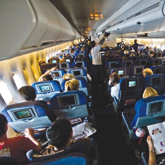 Passengers sitting inside an airplane [illustrative] (credit: Wikimedia Commons)