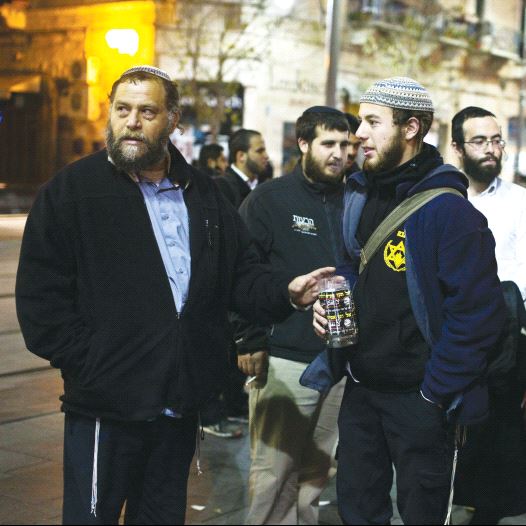 Ben-Zion Gopstein (left), leader of the group Lehava, gathers with some of his young followers in Jerusalem in 2014 (credit: REUTERS)