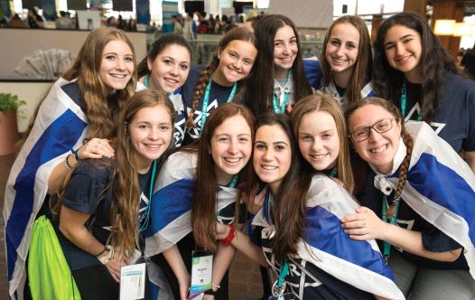 Teenage girls smile while attending the BBYO international convention in Dallas.