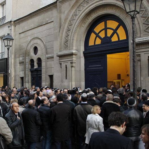 People gather outside the Notre-Dame de Nazareth synagogue in Paris March 19, 2012 to pay tribute to the four victims killed by a gunman at a Jewish school in Toulouse (credit: REUTERS)