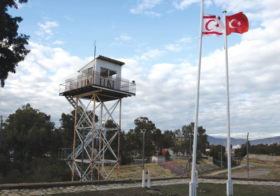 A UN guard post along the buffer zone of Cyprus and Northern Cyprus as a Turkish and Turkish-Cypriot flag wave nearby