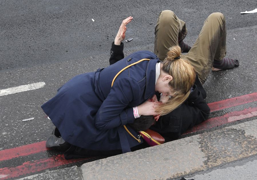 An injured person is assisted after an incident on Westminster Bridge in London, Britain March 22, 2017. (Reuters)
