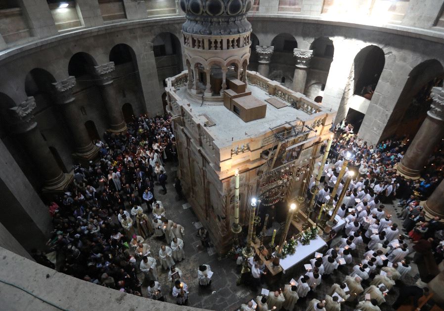 Christian worshippers in Israel surround the Edicule as they take part in a Sunday Easter mass procession in the Church of the Holy Sepulchre in Jerusalem's Old City (credit: REUTERS)