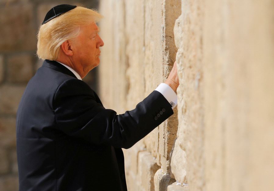 US President Donald Trump places a note in the stones of the Western Wall, Judaism's holiest prayer site, in Jerusalem's Old City May 22, 2017. (credit: REUTERS / JONATHAN ERNST)