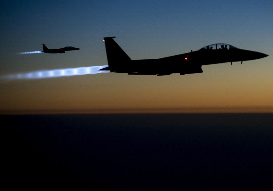 A pair of US Air Force F-15E Strike Eagles fly over northern Iraq after conducting airstrikes in Syria (credit: REUTERS)