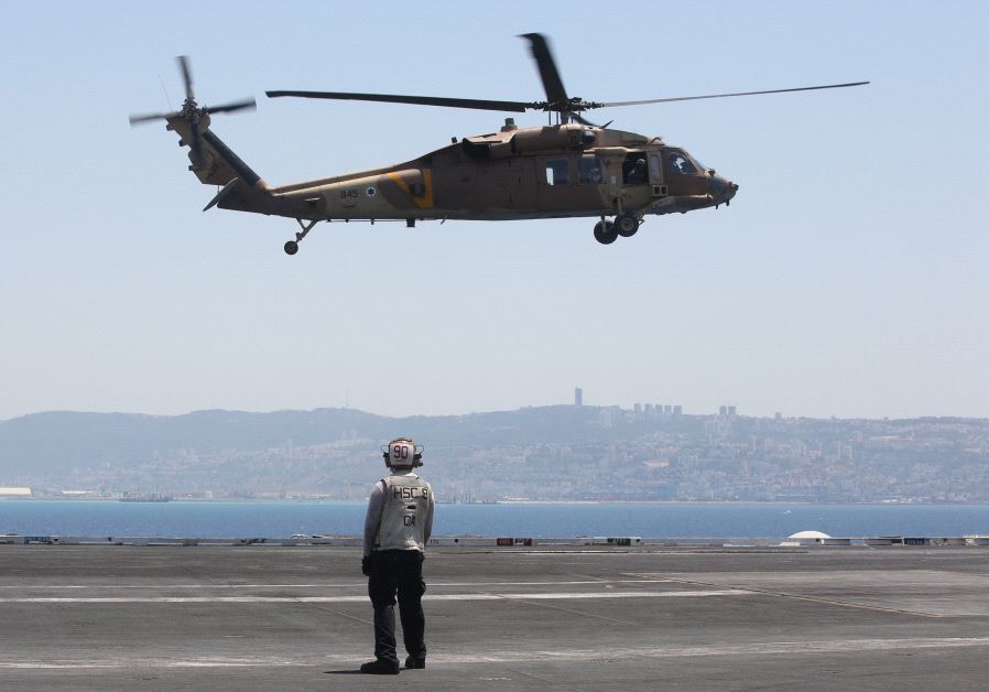 A helicopter lands on the USS George H.W. Bush docked in northern Israel's Haifa Port, July 3, 2017 (Marc Israel Sellem)