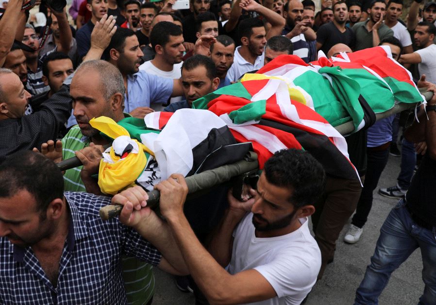 Mourners carry the body of Palestinian Mohammad Jebril during his funeral in Tekoa village near the West Bank city of Bethlehem July 11, 2017. (Reuters)