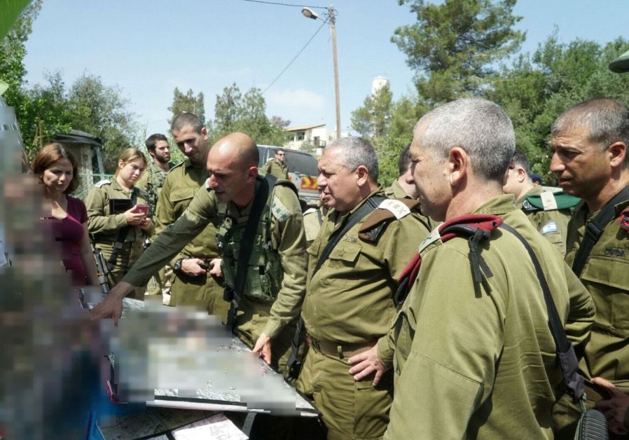 IDF Chief of Staff Lt.-Gen. Gadi Eisenkot is briefed by senior IDF officers at the scene of the attack in Halamish, July 22, 2017. (IDF Spokesperson's Unit)