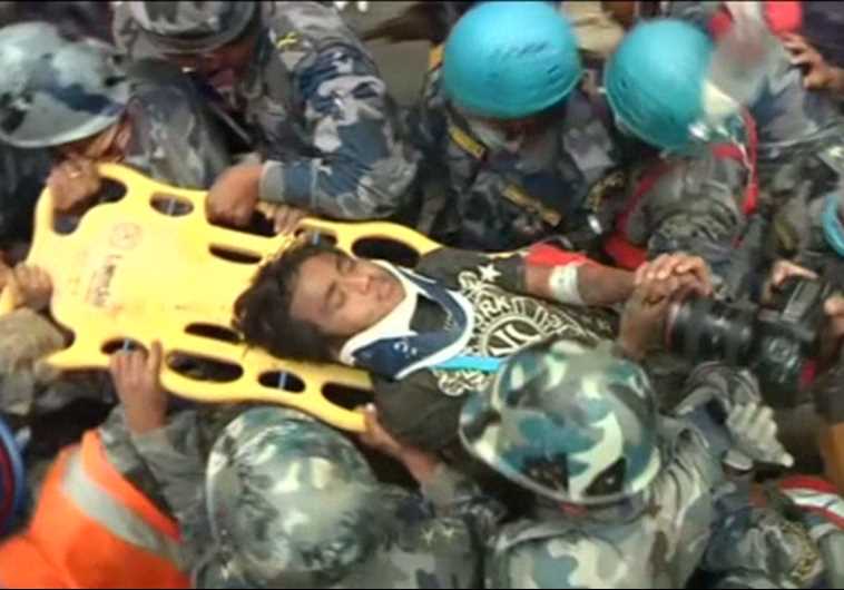 Teenager pulled out alive from rubble in Nepal.