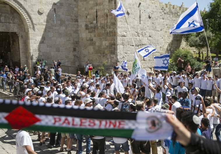 Flag march through Damascus Gate in Jerusalem's old city.