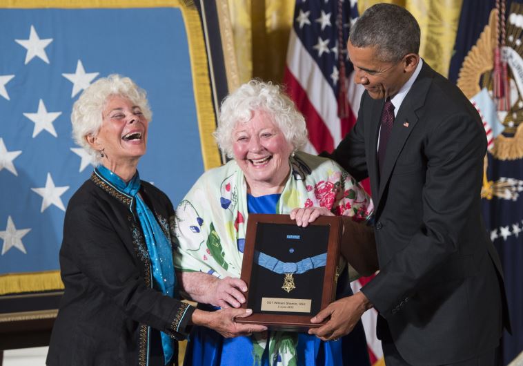 US President Barack Obama presents the Medal of Honor to Elsie Shemin-Roth (C) and Ina Bass (L), accepting on behalf of their late father, Army Sergeant William Shemin