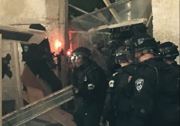 Security forces break barricade into al-Aksa Mosque.