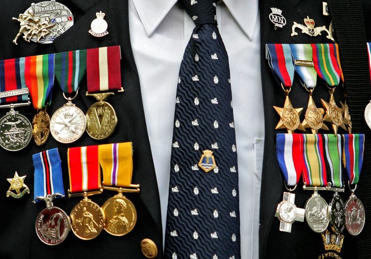 Medals are seen on the jacket of British World War II veteran during an event to mark VJ Day at the Imperial War Museum in London