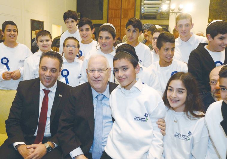 PRESIDENT REUVEN RIVLIN celebrates with the youngsters at the President’s Residence in Jerusalem, December 21, 2015