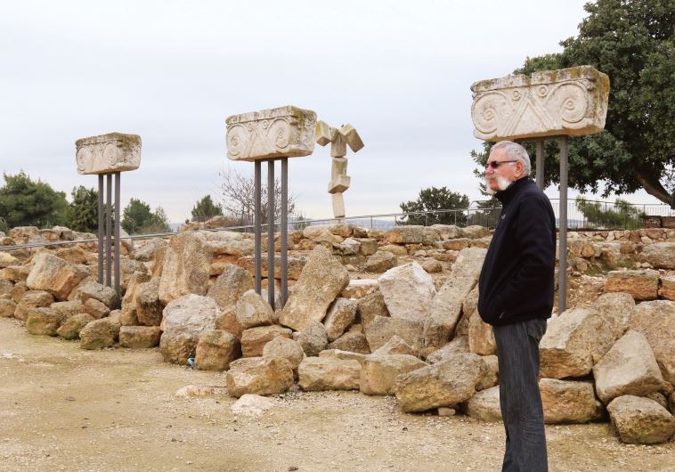 Kibbutz secretary Jossef Avi Yair Engel stands amid proto-Aeolic capitals