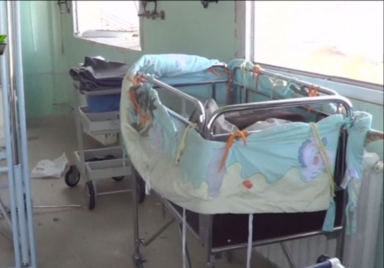 Missiles hit school and hospital in Syrian border town, 14 dead