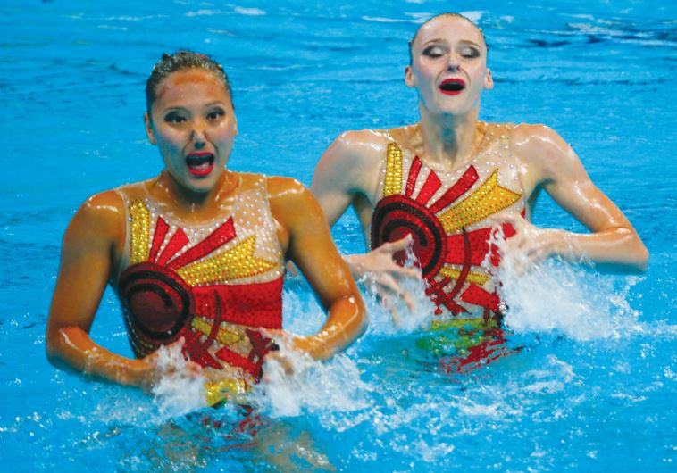Yulia Kim and Anastasiya Ruzmetova of Uzbekistan perform in the synchronized swimming duet technical preliminary round at the Aquatics World Championships in Kazan, Russia