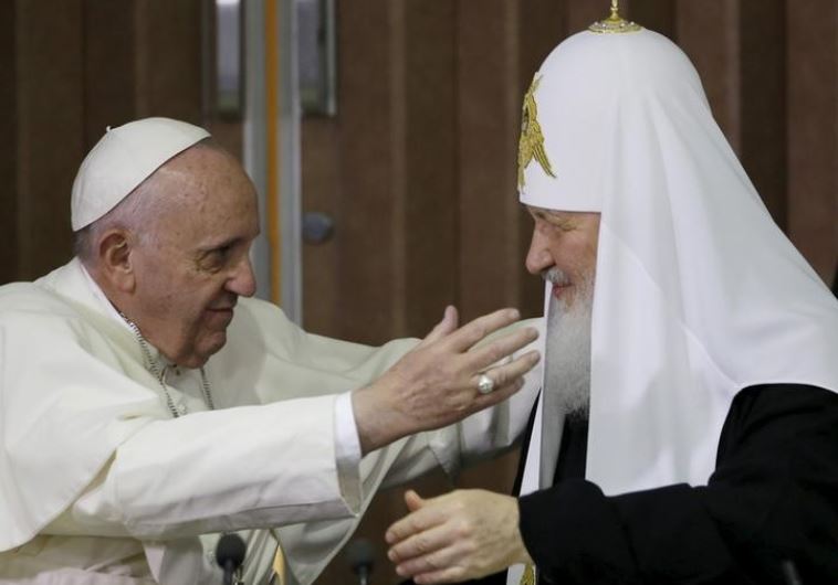 Pope Francis, left, reaches to embrace Russian Orthodox Patriarch Kirill after signing a joint declaration at the Jose Marti International airport in Havana, Cuba, Friday, February 12, 2016. 
