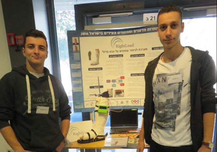 Shahar Ein-Kedem (left) and Bar Arama of Kiryat Tivon show project on device to sleep up healing of fractured legs in cast.