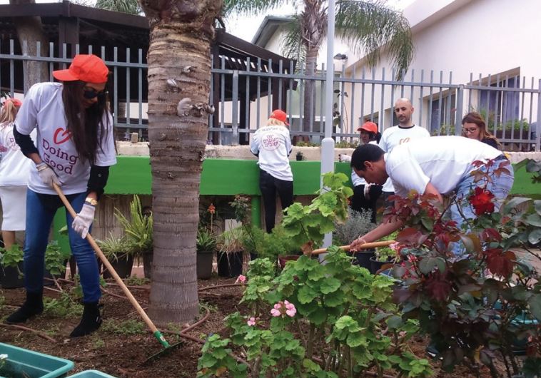 Electra employees plant a garden at a mental health center in Rishon Lezion