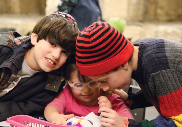 Decorating masks in time for Purim, at the first Meet in the Tower event for families with children with additional needs at the Tower of David Museum