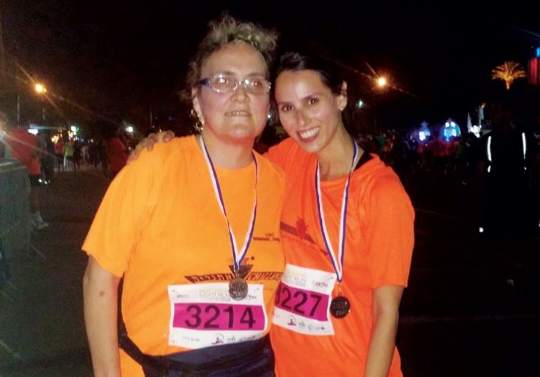 ‘I don’t feel the least bit of danger when I run with her’: Kadar (left) at the Beersheba night run, with sighted teammate Dana Kariti.
