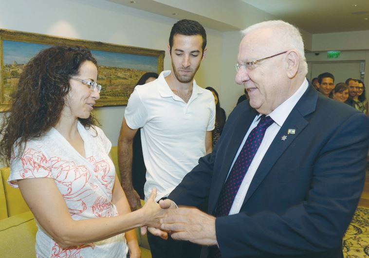 PRESIDENT REUVEN RIVLIN greets Mika Banki, mother of Shira Banki, at the President’s Residence yesterday.
