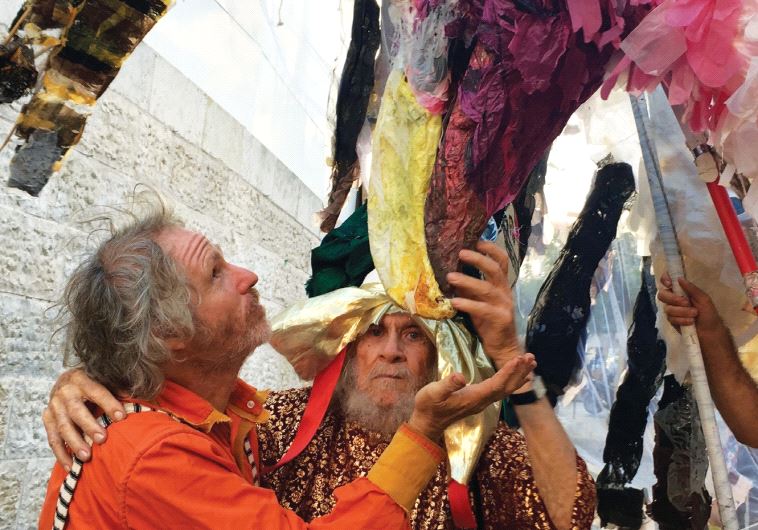 Puppeteer Adam Yachin gets up close to one of his large creations, together with his 92-year-old puppeteer father
