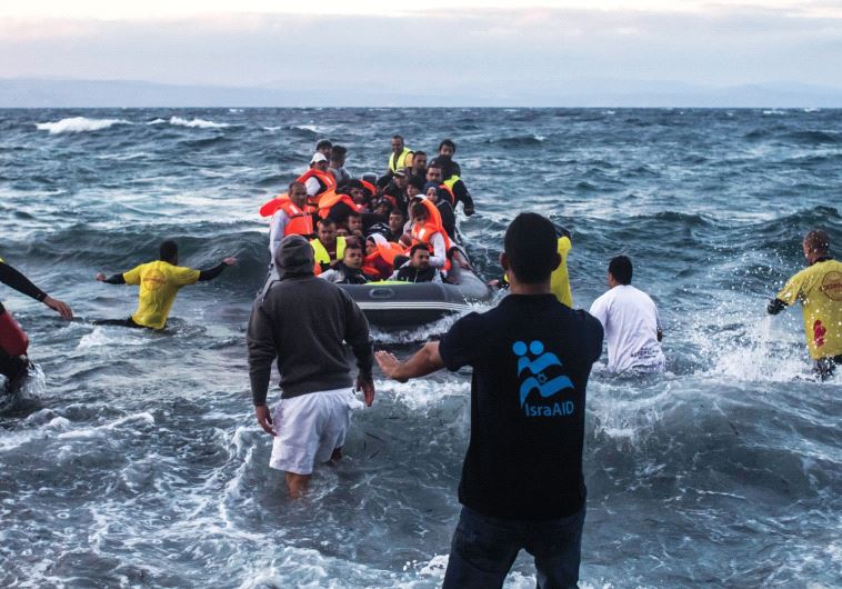 IsraAid workers bring refugees ashore in Lesbos, Greece