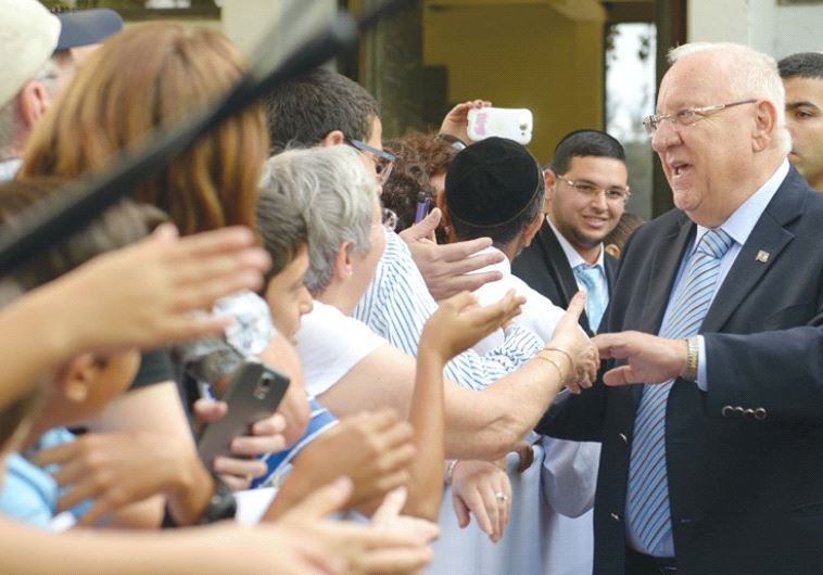 PRESIDENT REUVEN RIVLIN shakes hands with visitors at the President’s Residence.