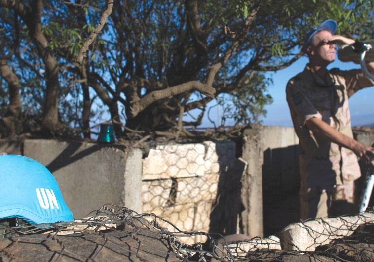A UN soldier keeps watch on the Golan Heights