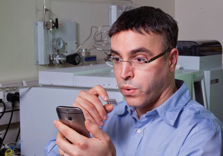 PROF. HOSSAM HAICK breathes on a sensor he developed that is capable of identifying various chronic diseases by analyzing components in a person’s breath.