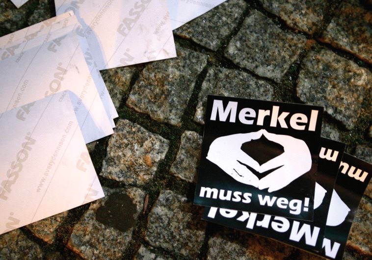 STICKERS WITH the words ‘Merkel must go’ lie on the pavement during a protest in Berlin.
