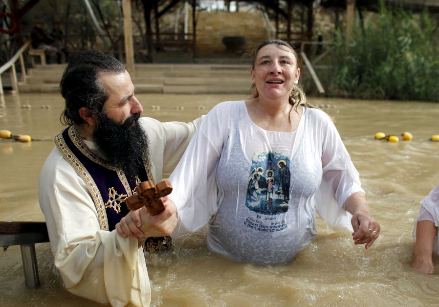 A Christian pilgrim is baptized during a ceremony at the baptismal site known as Qasr el-Yahud on the banks of the Jordan River.