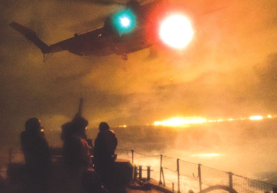 A YASUR helicopter hovers over a Super Dvora patrol boat during a joint navy-air force drill on Wednesday