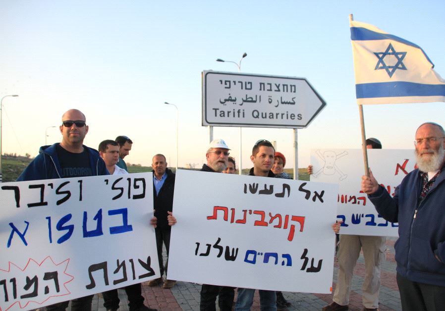 Settlers holding a small demonstration on the new paved turn-off to the road