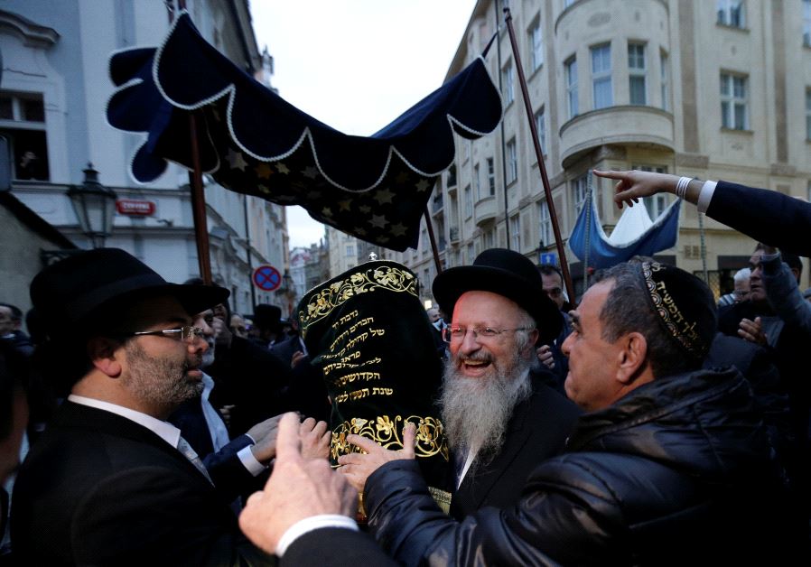 Members of the Czech Jewish Community dance with new Torah scrolls in front of the medieval Old-New Synagogue in Prague March 19, 2017