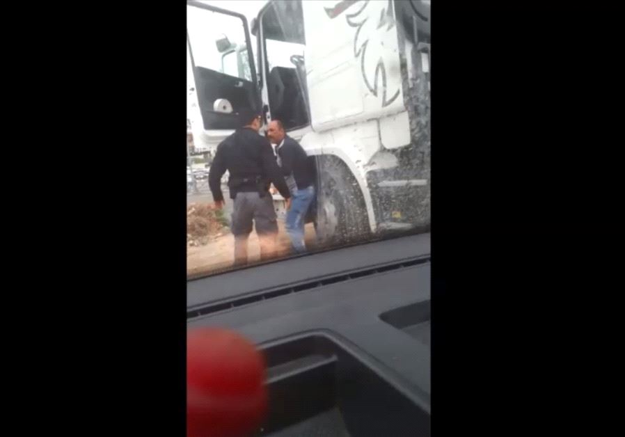 Israeli police officer violently confronts truck driver‏