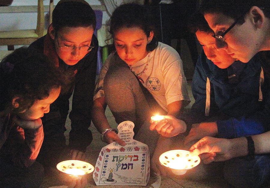 MEMBERS OF the Nataf family take part in ‘bedikat hametz’ ritual in Jerusalem.