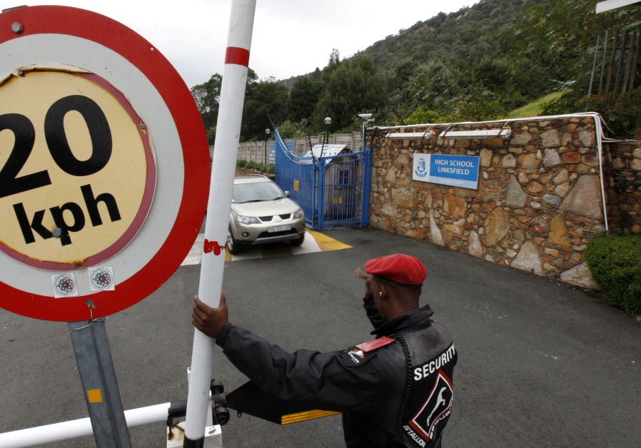 A security guard keeps watch at the entrance of King David School High School in suburban Johannesburg, March 15, 2012.