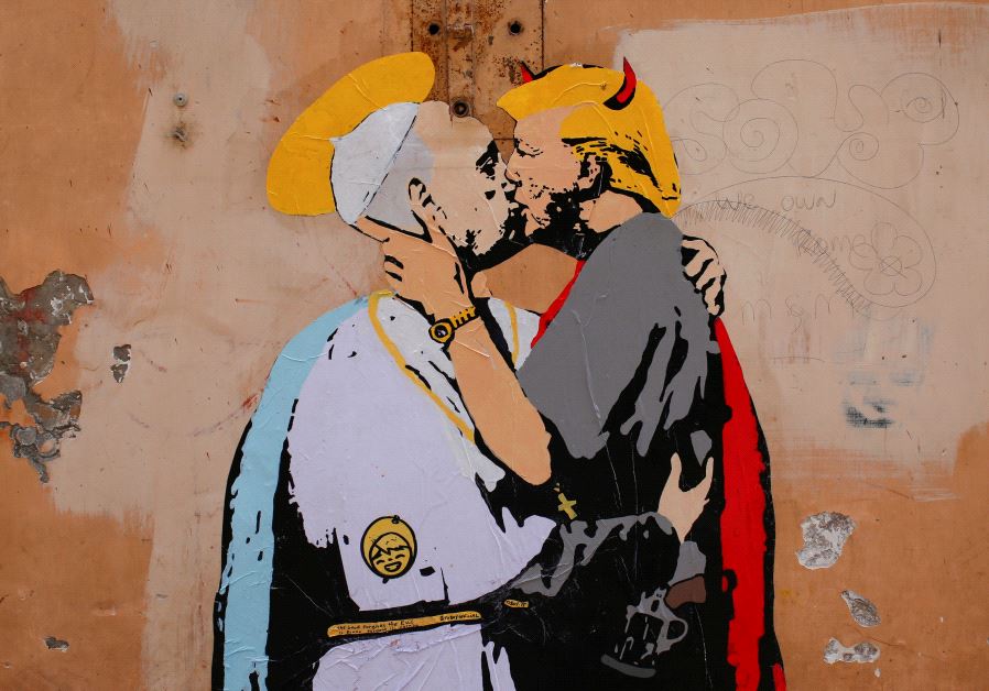 A mural signed by "TV Boy" and depicting Pope Francis and US President Donald Trump kissing, is seen on a wall in downtown Rome, Italy May 11, 2017