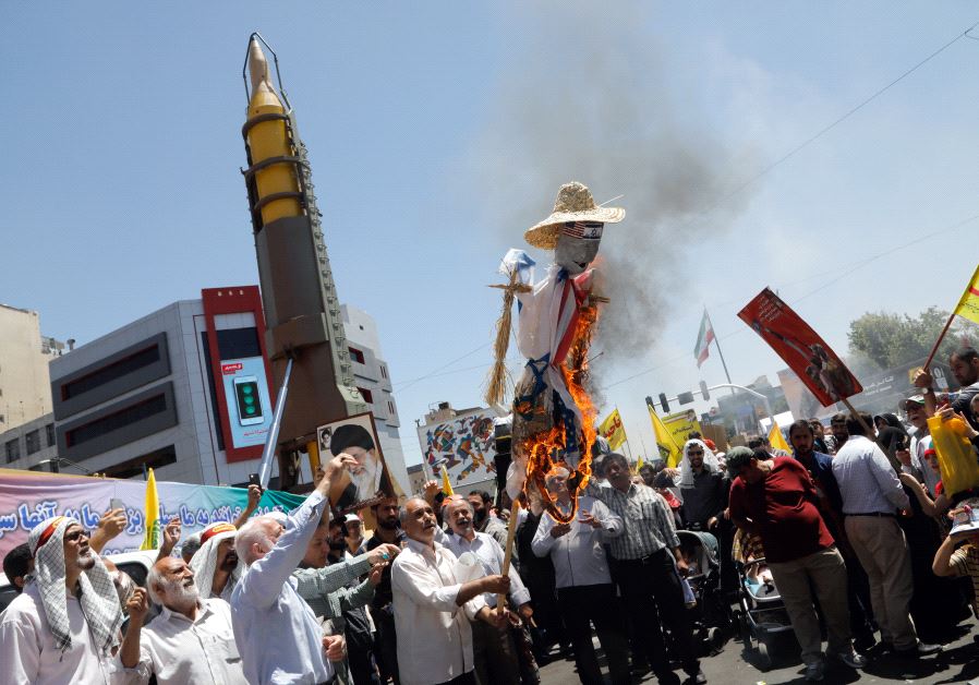 Iranians burn anti US and Israeli effigies during in a rally marking al-Quds (Jerusalem) Day in Tehran on June 23, 2017.